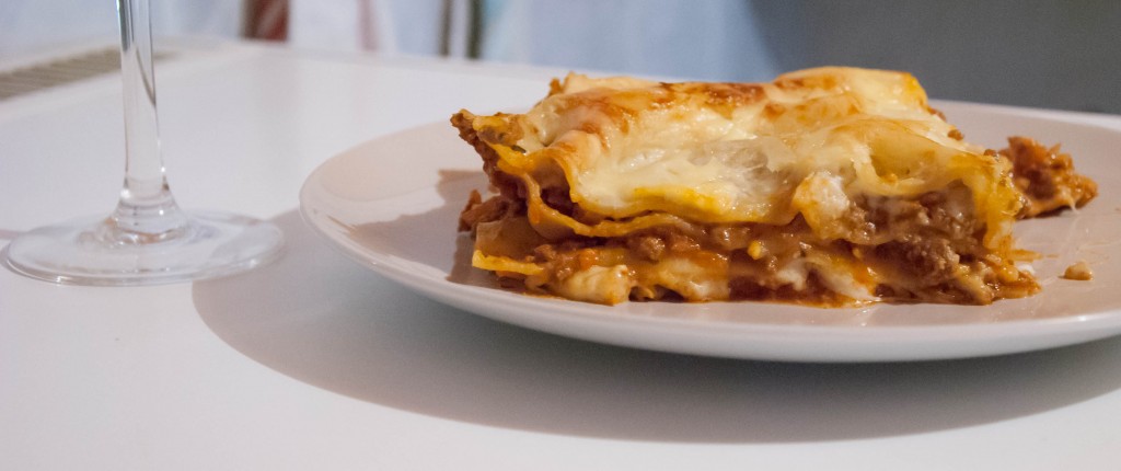 Lasagne al forno with wine glass